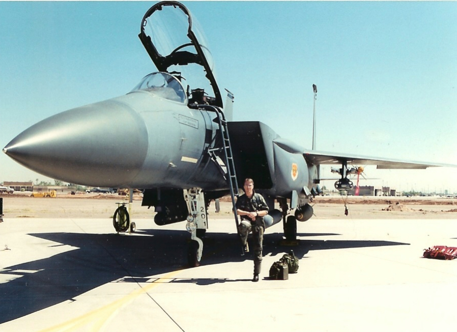 Dr. Kurt Reesman standing beside an F-15E Strike Eagle on the flight line